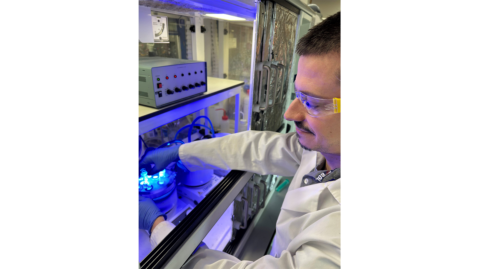 Dr Mattia Silvi wearing goggles and gloves working in a laboratory