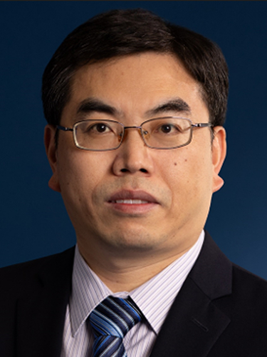 A professional headshot of Dr Shuhui Sun, against a dark blue background, wearing a dark suit jacket.