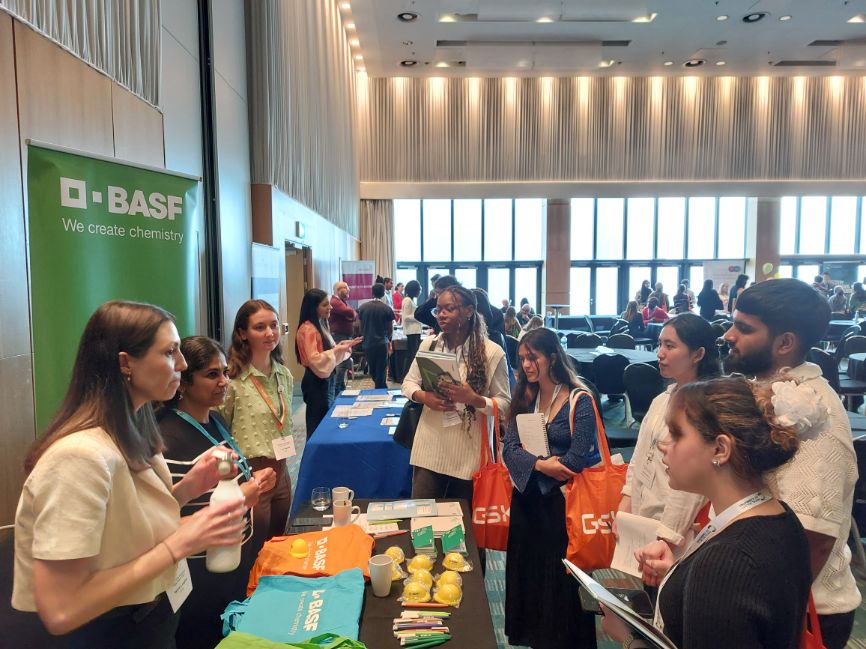 Several programme participants visit the stall of BASF