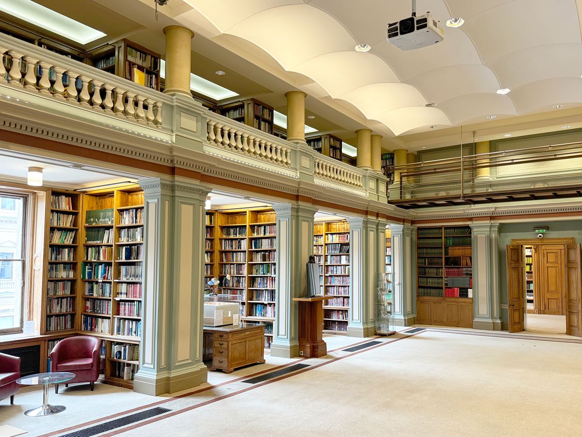 RSC Burlington House library showing bookshelves, chairs and ornate pillars and balcony