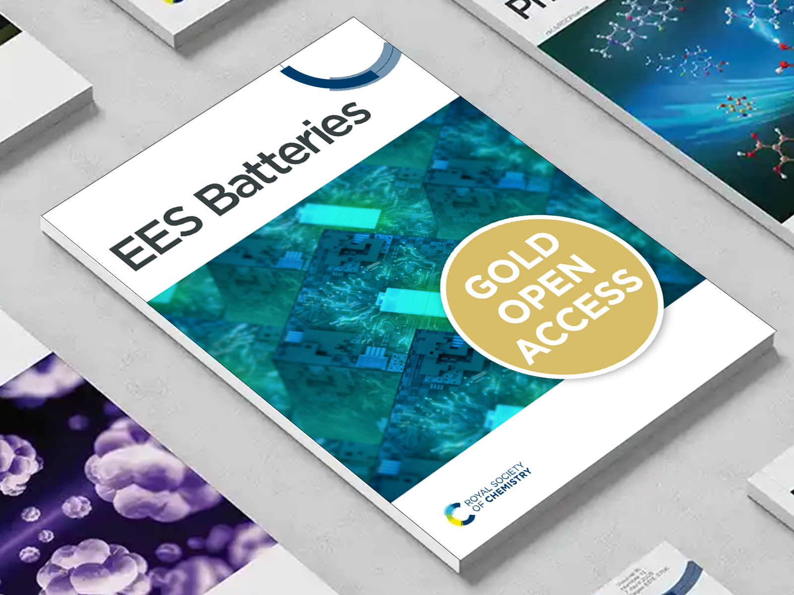 the EES Batteries journal among a group of other journals on a desk