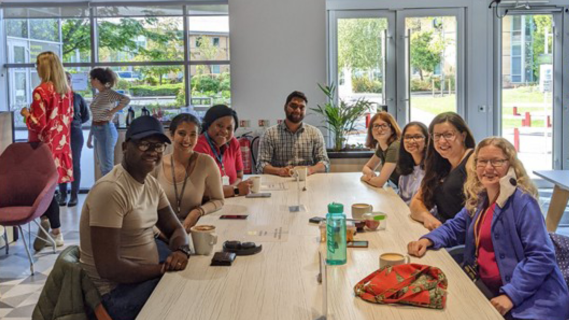 University of York "Decolonising the Chemistry Curriculum" Group at long desk posing for camera