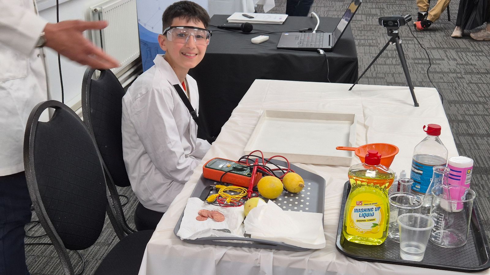 Syrian refugee school child at chemistry workshop with lemon battery