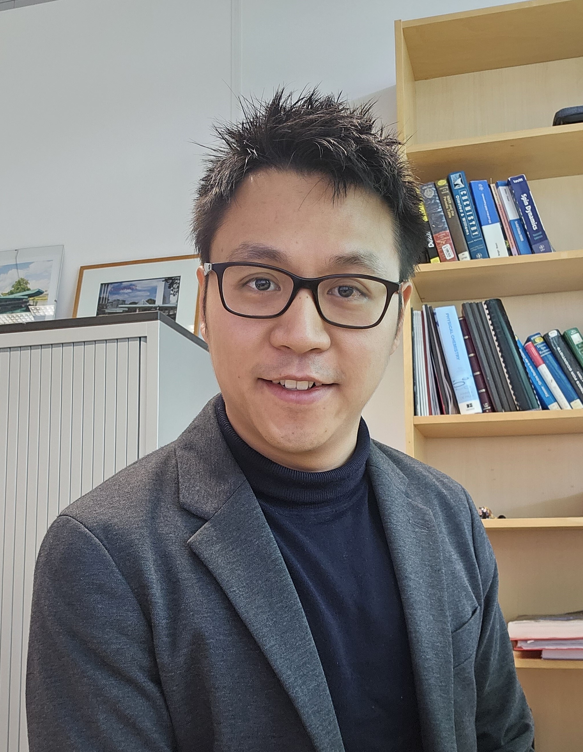 a man in glasses smiling