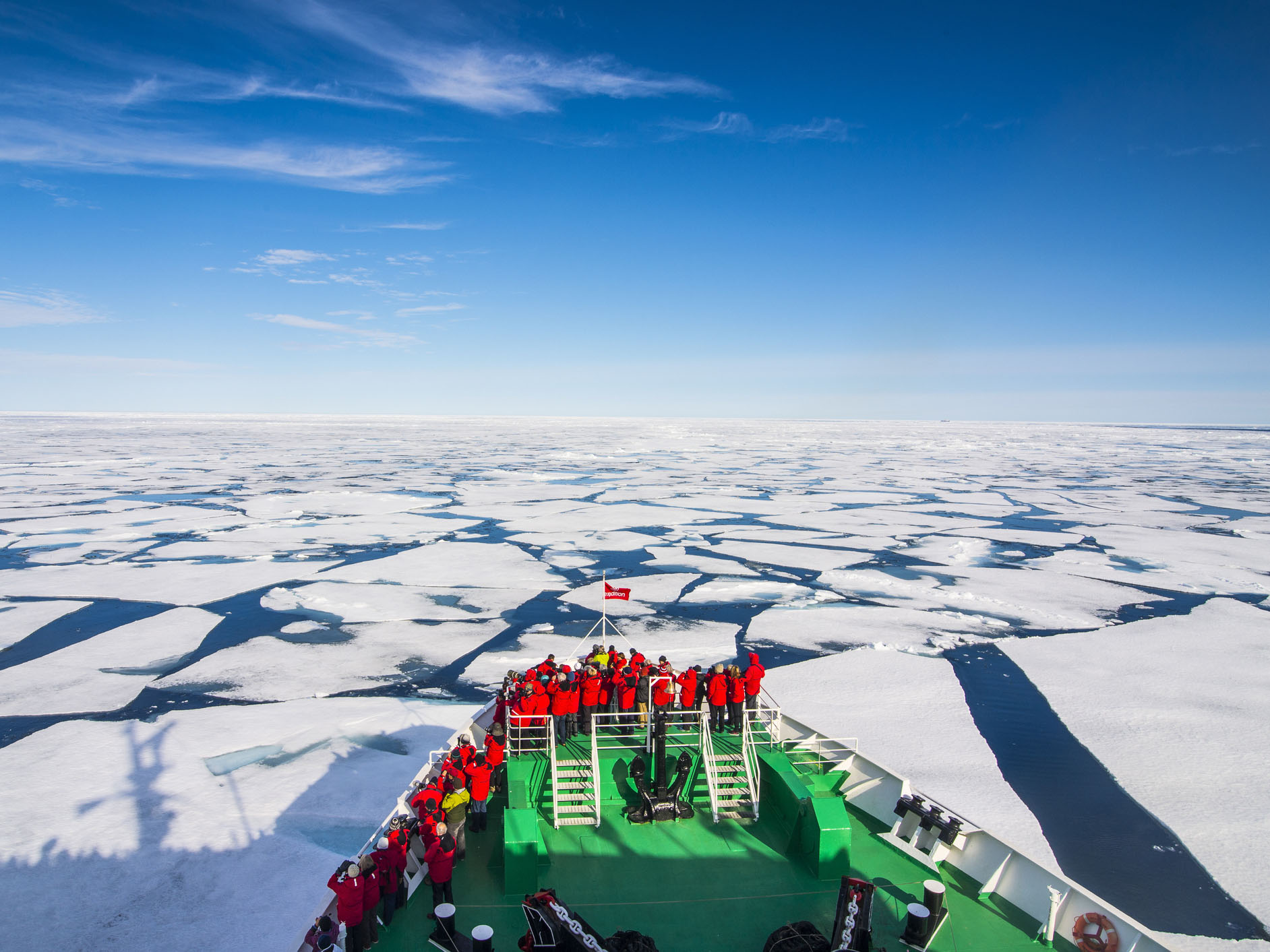Expedition boat navigating through the pack ice in the Arctic shelf