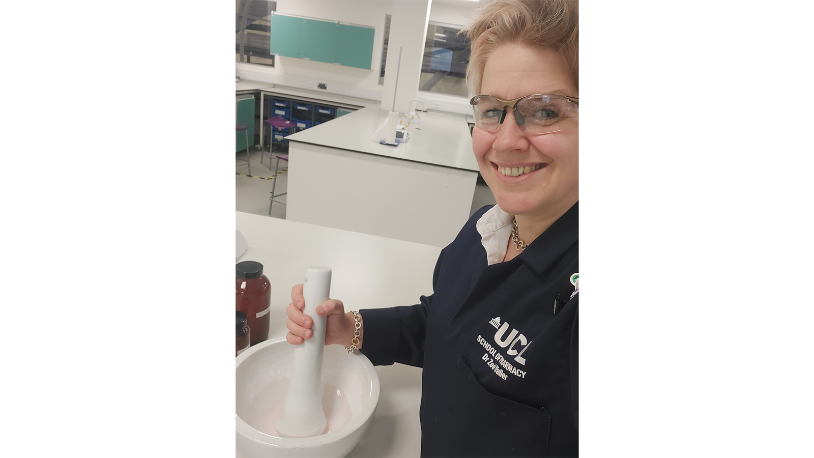 Zoe wearing glasses, with large pestle and mortar and UCL navy sweatshirt on