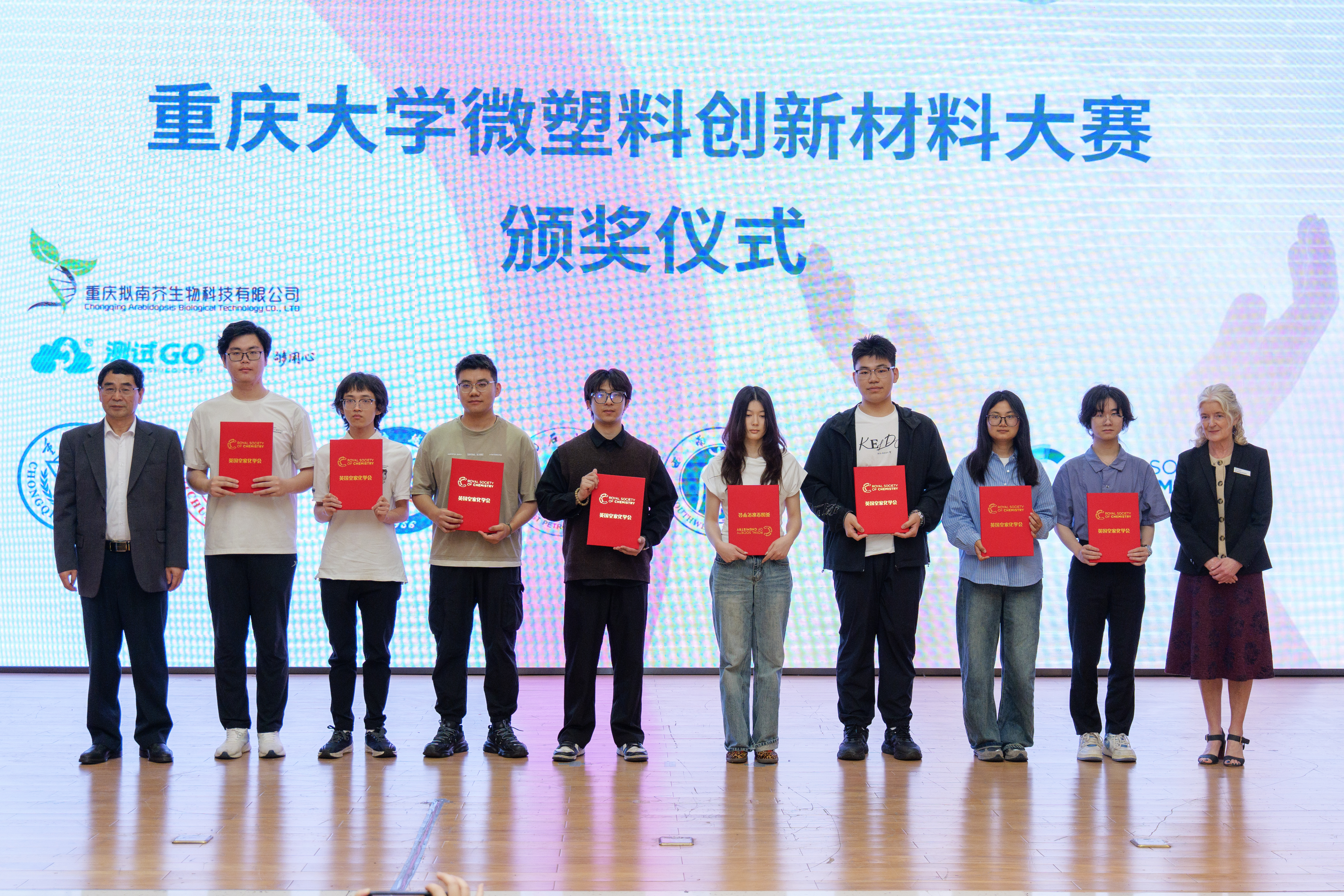 a group of people holding red papers