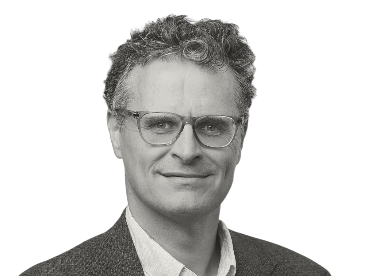 Javier Perez-Ramirez in black and white, wearing glasse, shirt and suit jacket and smiling to camera