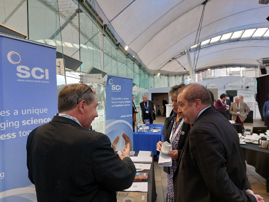 Graeme Dey MSP talks with a representative from SCI as he visits one of the exhibition stalls during a break at Science and the Parliament