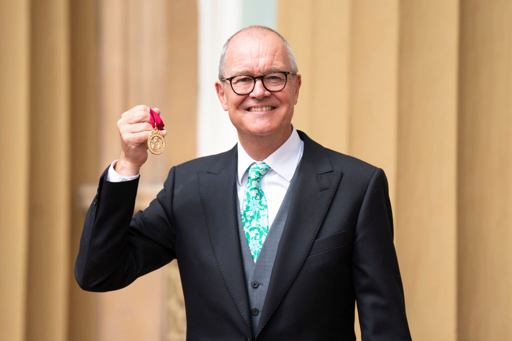 Sir Patrick Vallance holds up his medal after he was made a Knight Commander during an investiture ceremony at Buckingham Palace on June 7, 2022