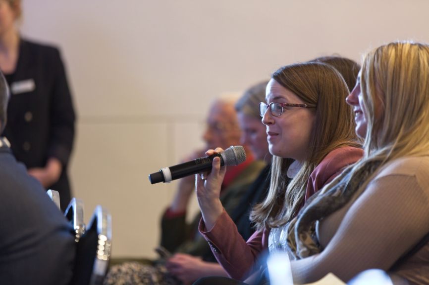 An audience member asks a question of the panel