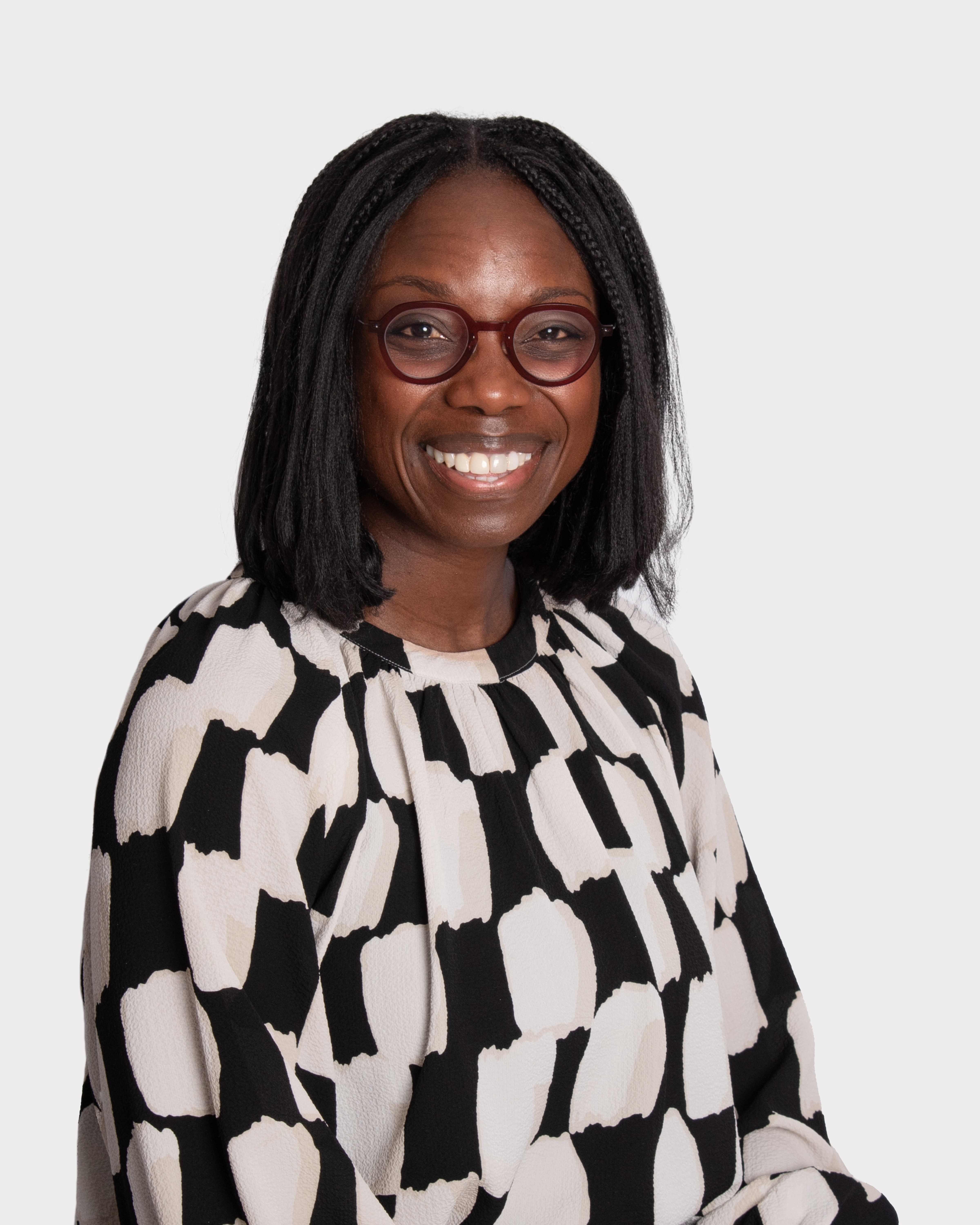 a woman wearing glasses and a black and white patterned shirt