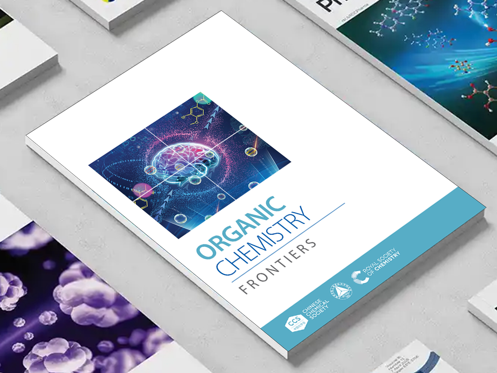 the Organic Chemistry Frontiers journal among a group of other journals on a desk