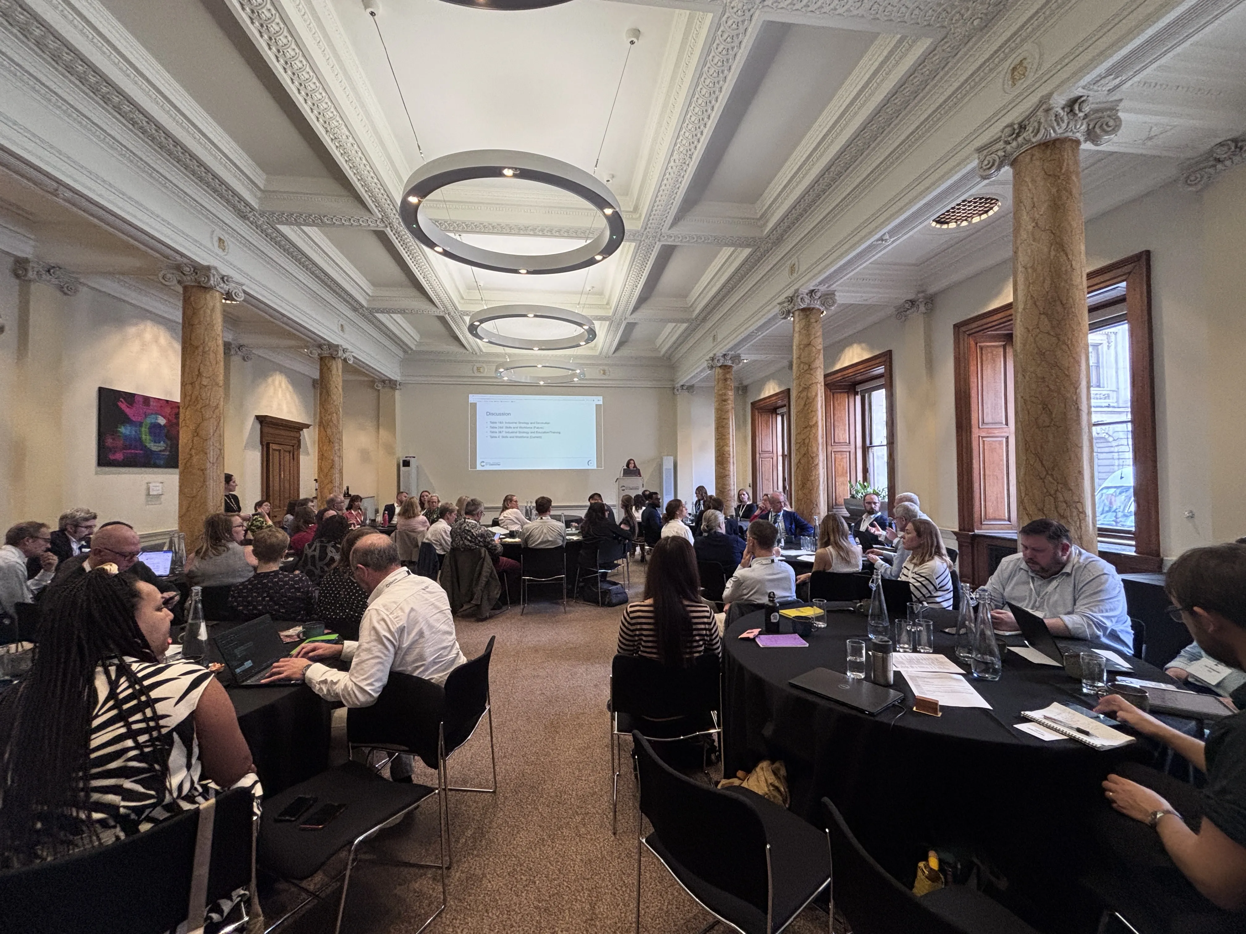 Chemicals Policy Roundtable - pic 1 a group of people sitting at tables in a room with columns