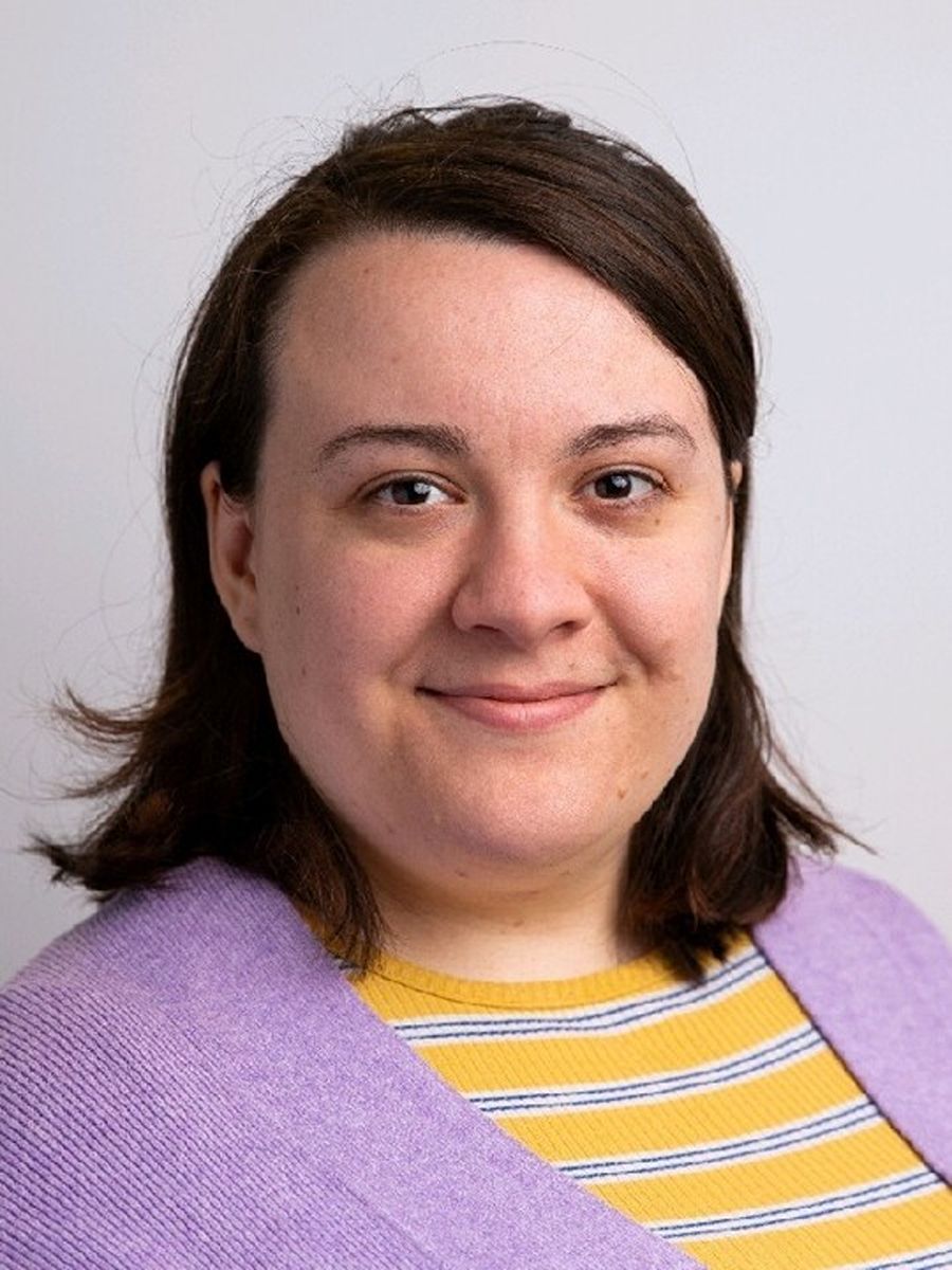 Grace Thoburn smiling to camera in pink top