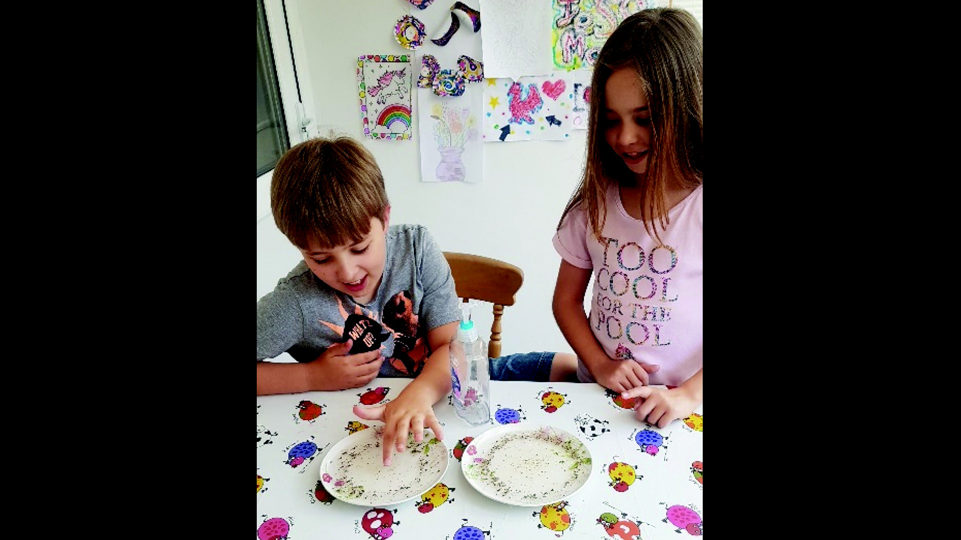 Two young children doing creative or experimental artwork