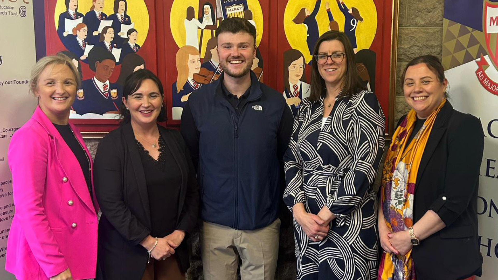 Conor Eivers with team, all smiling to camera