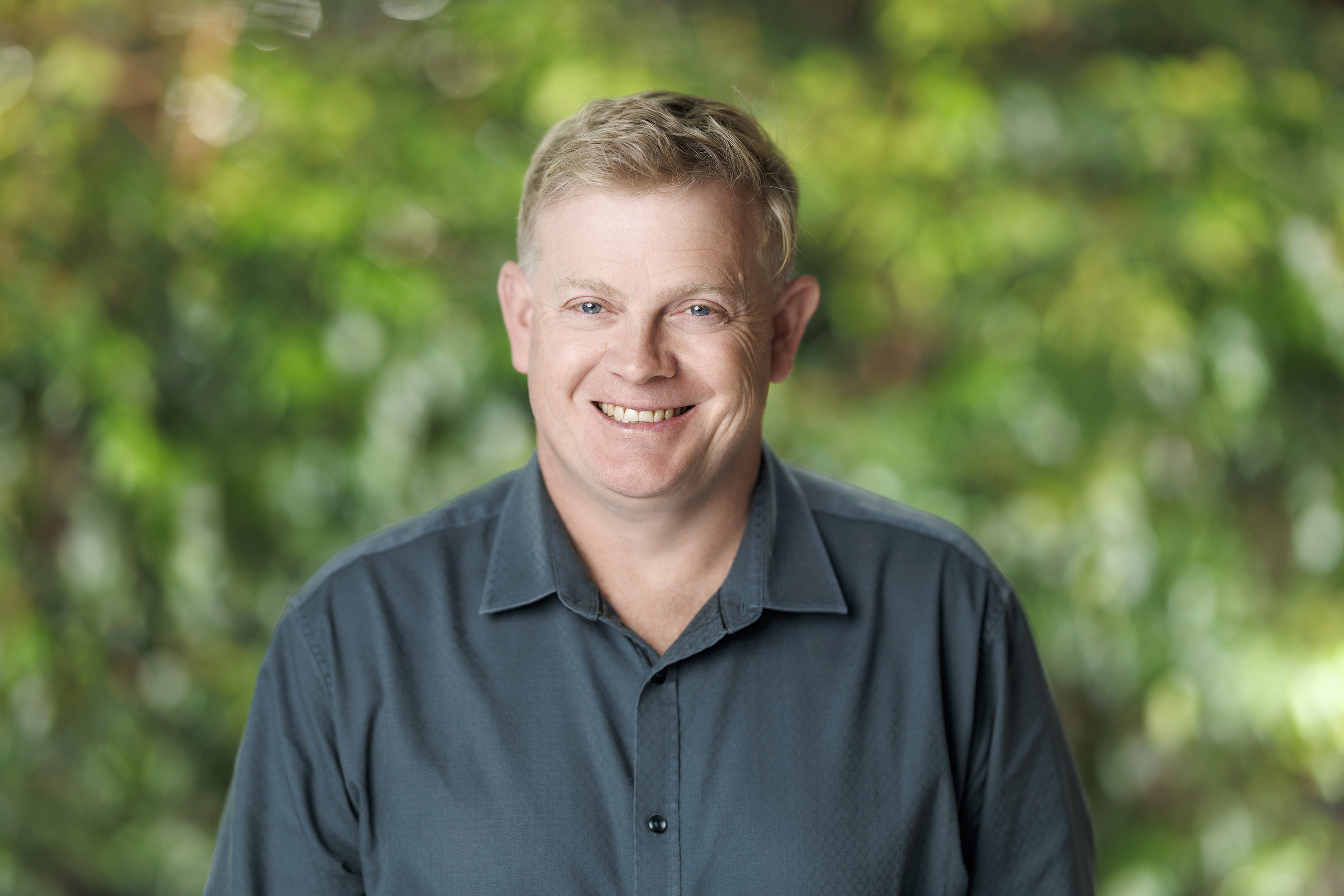 a man smiling at the camera