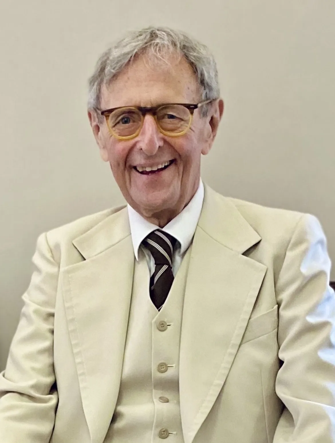 Kenneth Wallace Smalldon deceased Kenneth Wallace Smalldon smiles widely to camera in 3 piece cream suit and tie and wearing glasses