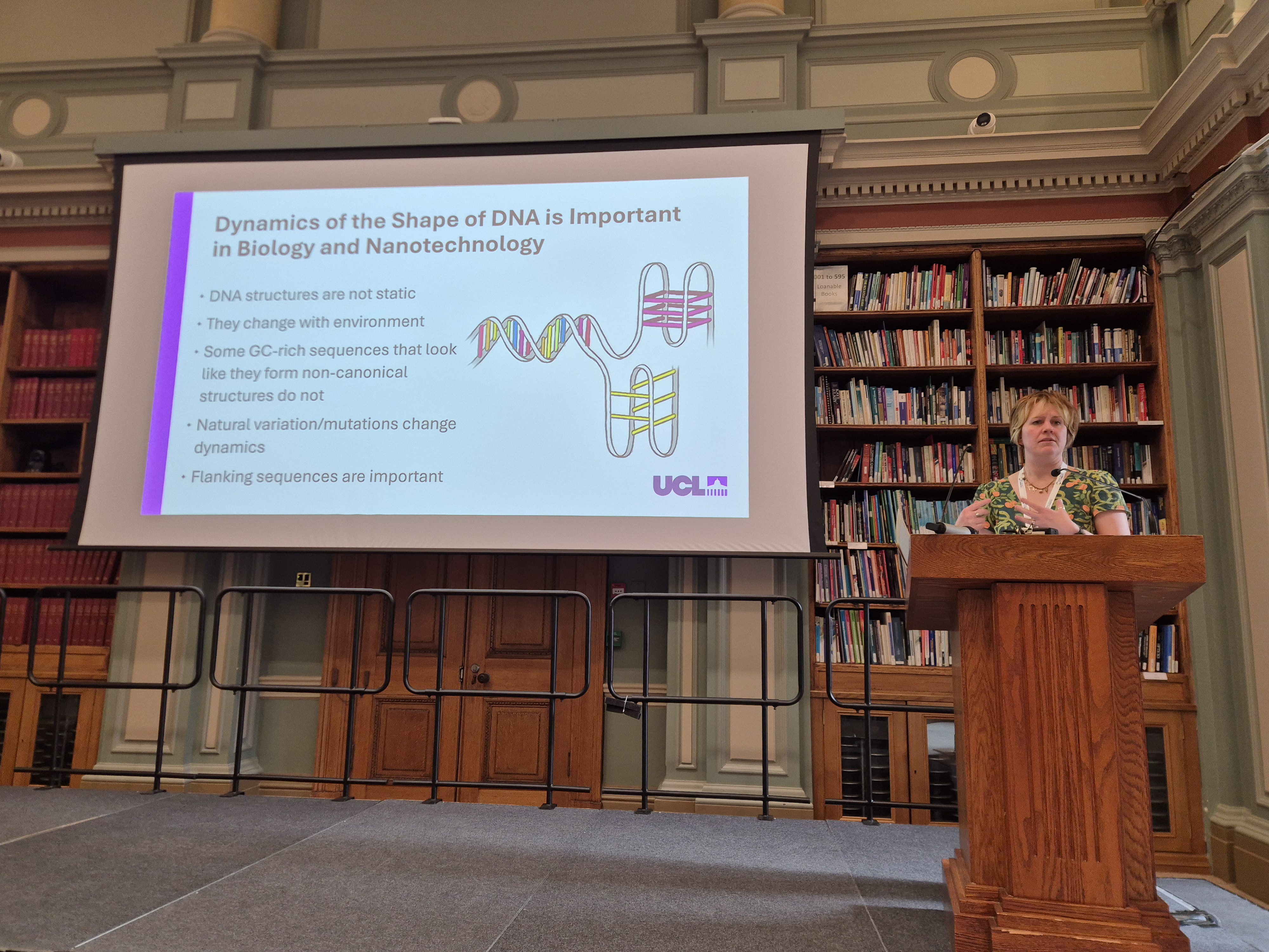 2026 Chemical Biology Symposium - Professor Zoe Waller addresses delegates (1) Professor Zoe Waller stands at a podium in front of a large screen