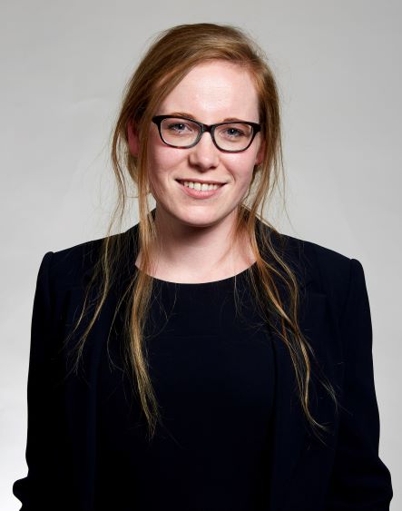 a woman wearing glasses and a black shirt