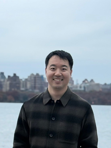 Min-Sub Lee smiling wearing dark grey shirt 