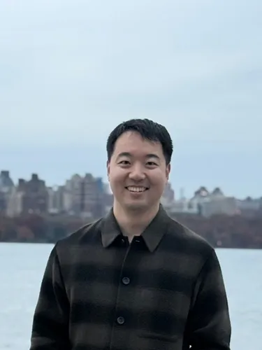 Min-Sub Lee Min-Sub Lee smiling wearing dark grey shirt