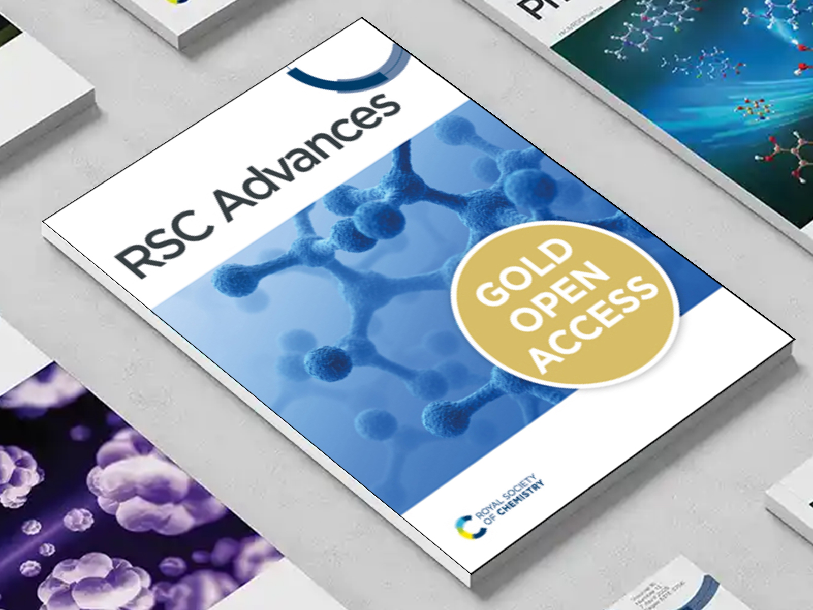 the RSC Advances journal among a group of other journals on a desk