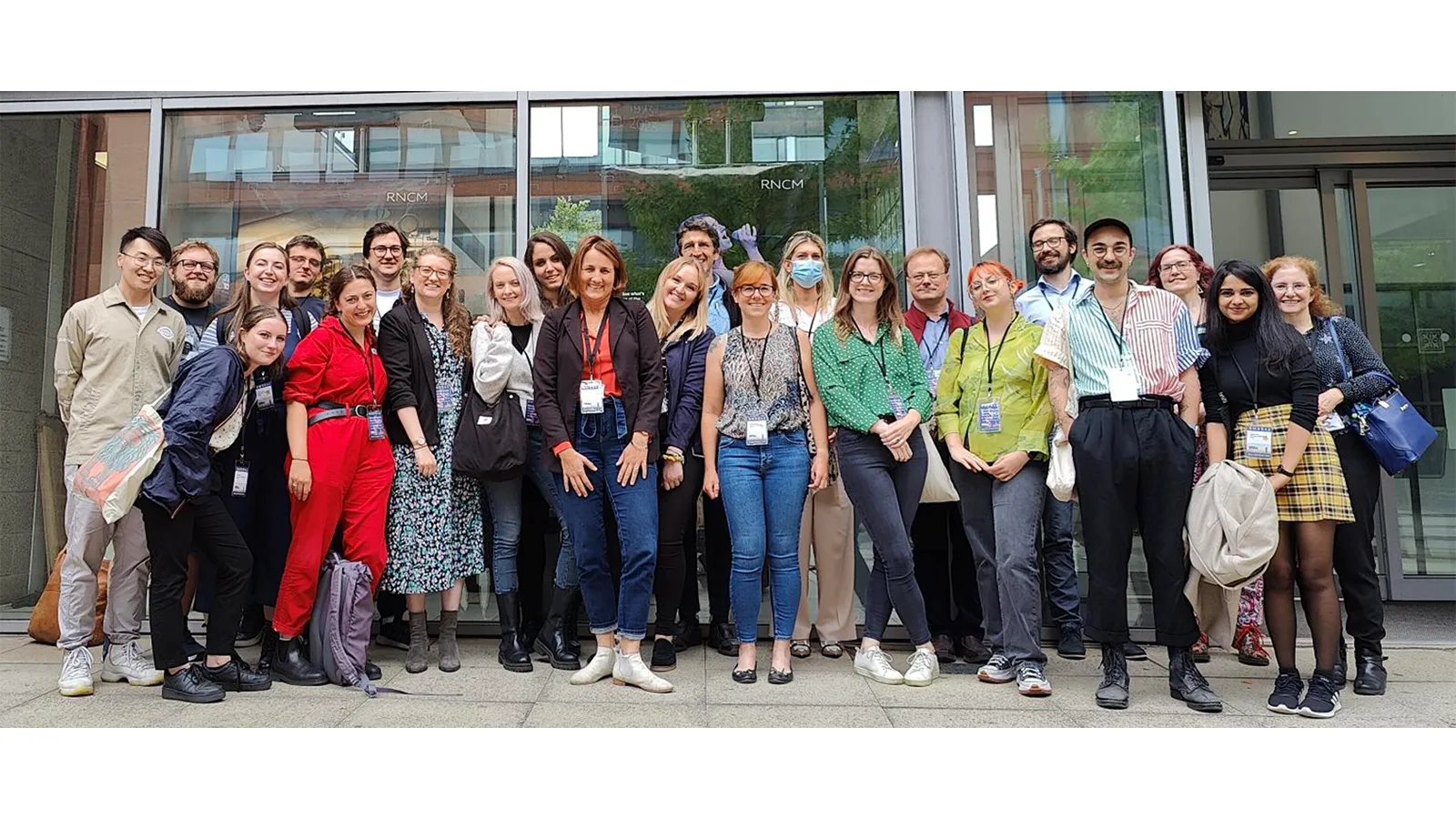 Professor Perdita Barran with large group of colleagues standing in every day clothes outside their building
