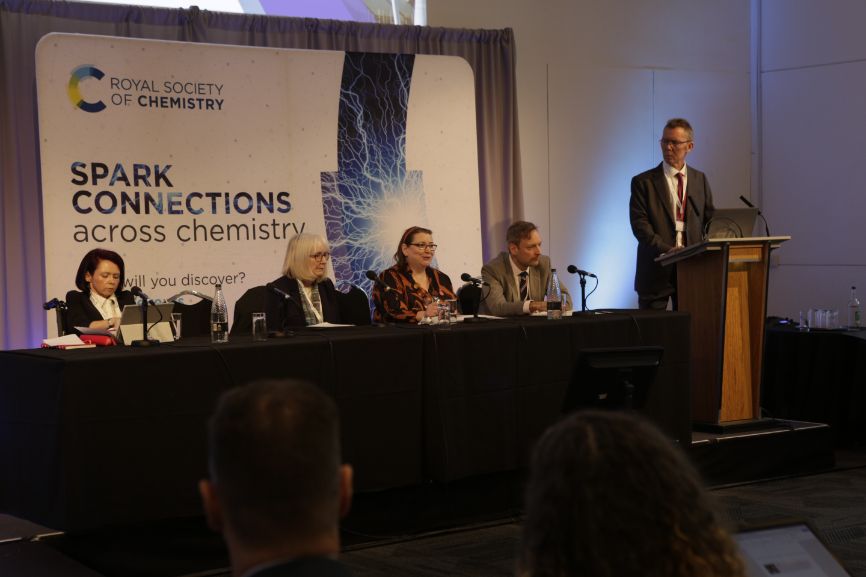 The MSPs sit at a desk on stage during their panel discussion