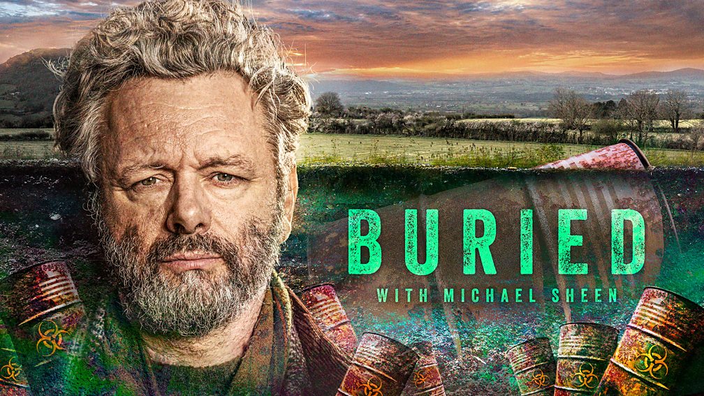 Michael Sheen and a field of grass, with "Buried with Michael Sheen" overlaying the field