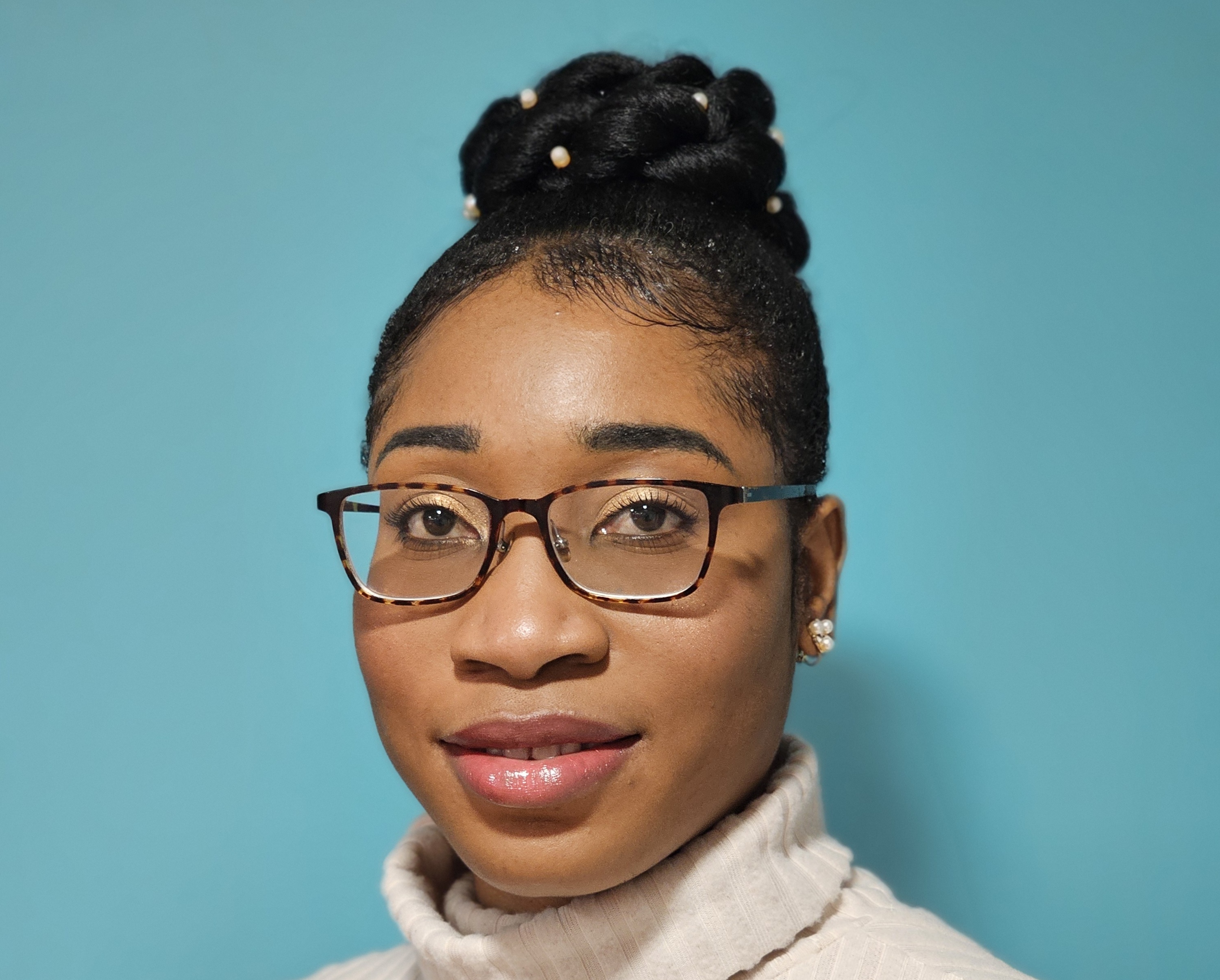 a woman wearing glasses and a turtleneck