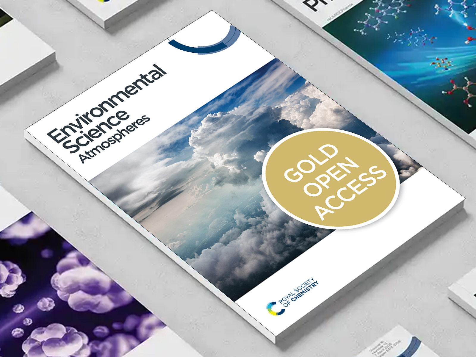 the Environmental Science Atmospheres journal among a group of other journals on a desk