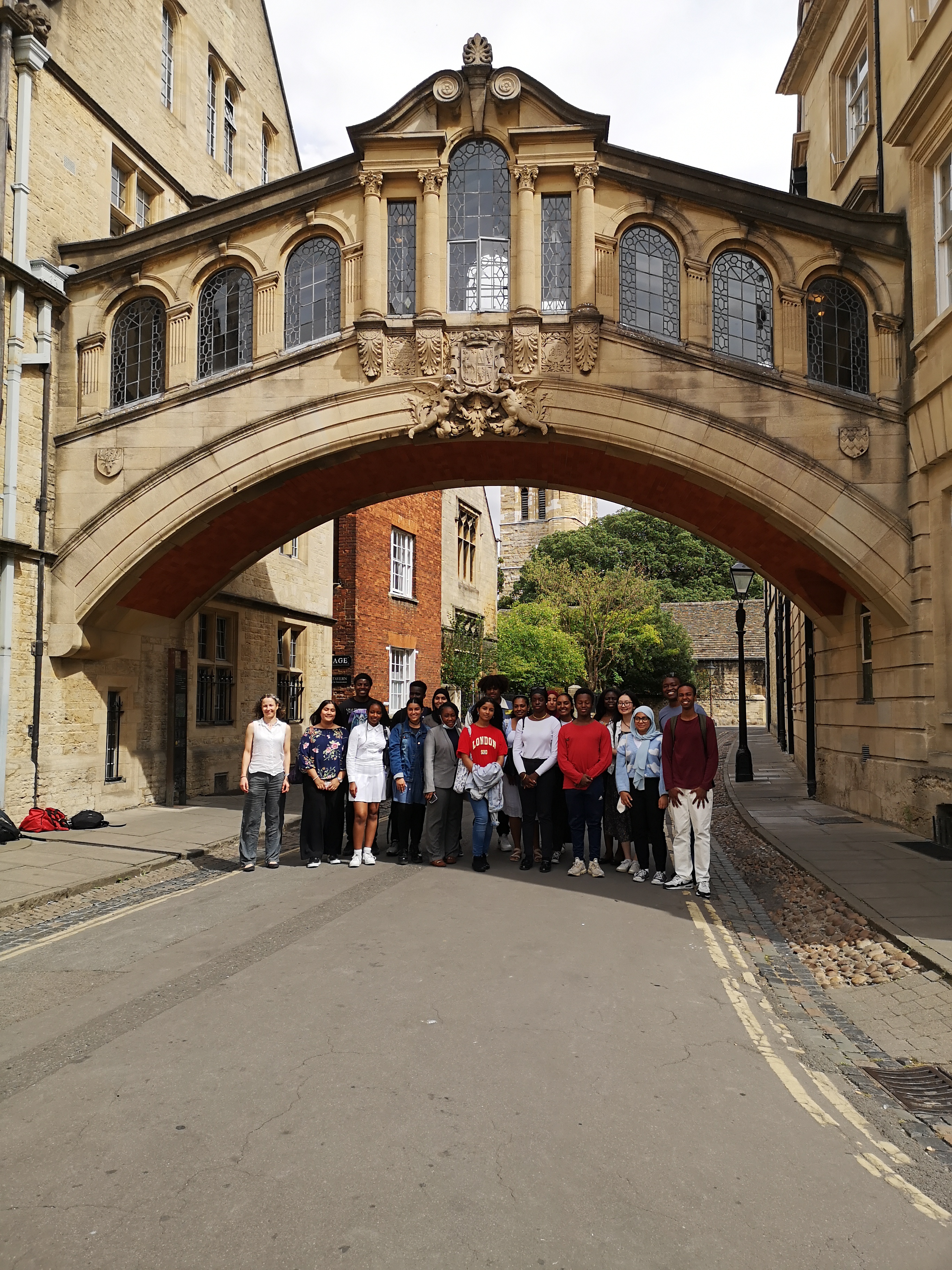 Group of people under bridge