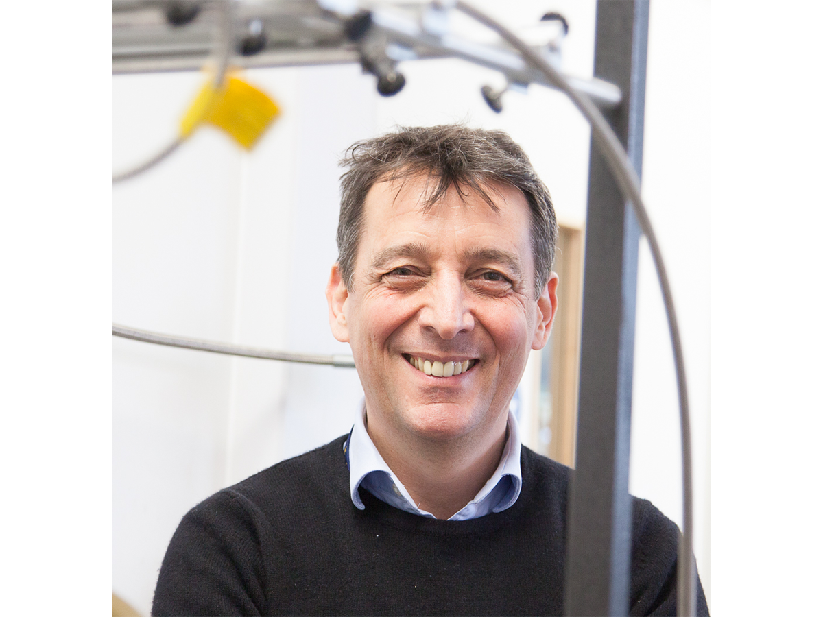Professor Paul Walton headshot, smiling in open necked shirt and jumper