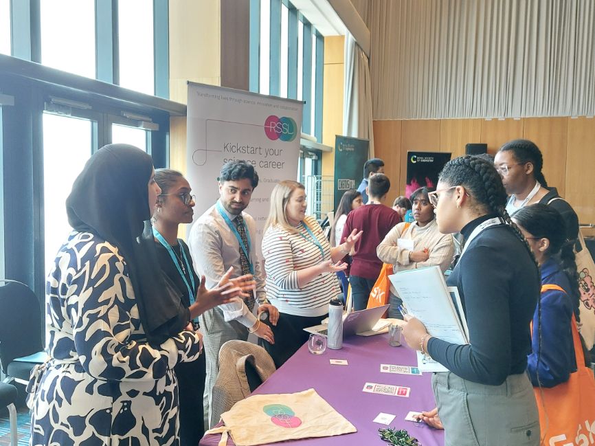 Several programme participants visit the stall of RSSL