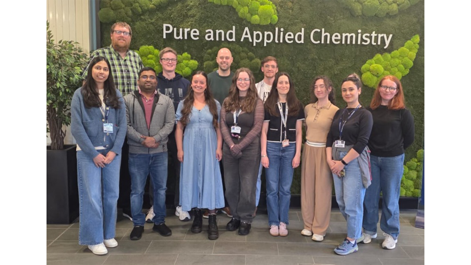 Professor Damion Corrigan and team face to camera outsdie in front of greenery