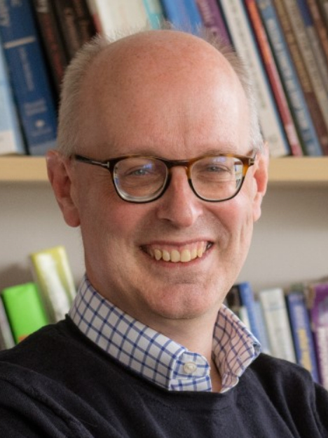Michael Ward wearing glasses and smiling