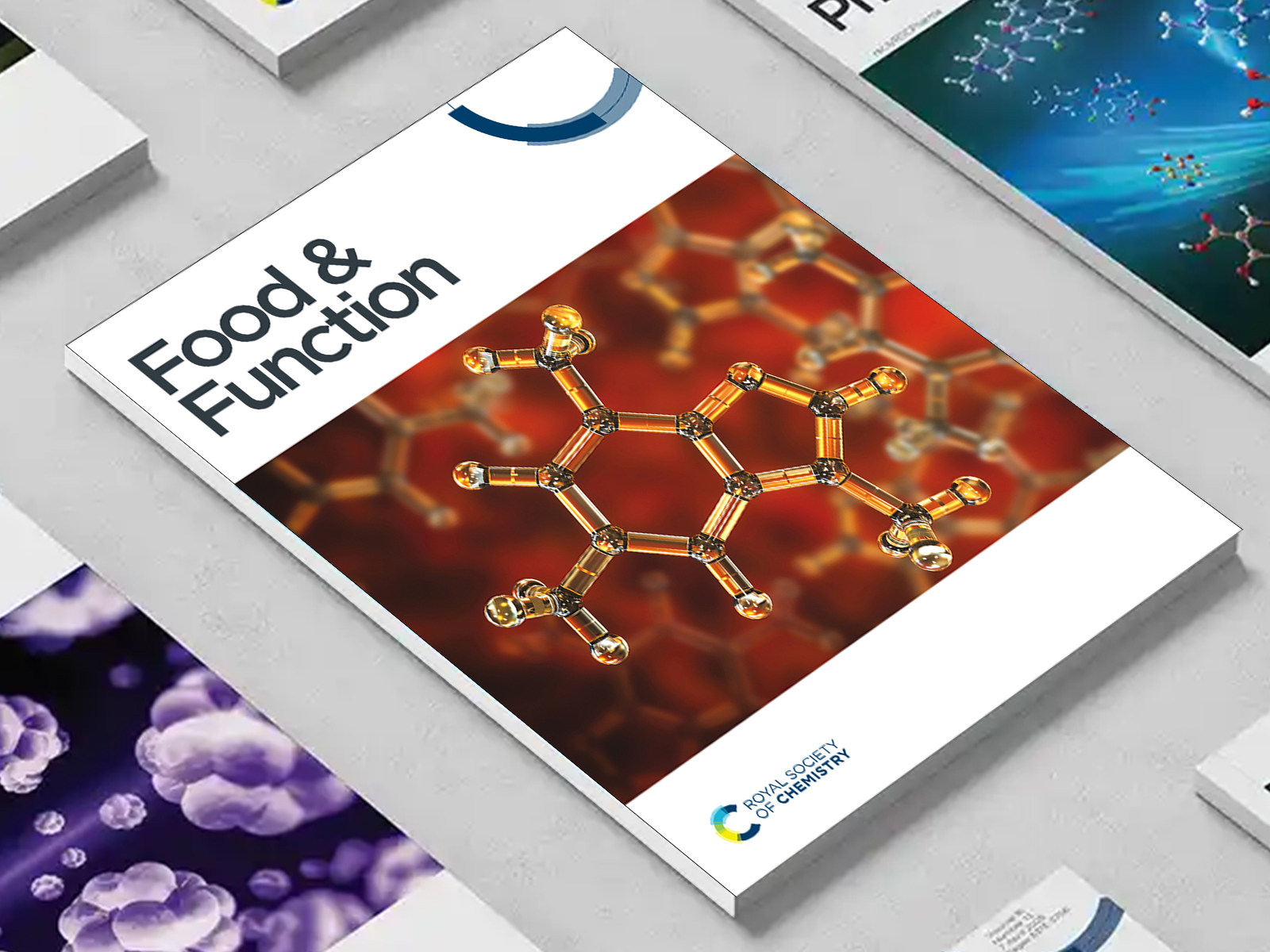 the Food & Function journal among a group of other journals on a desk