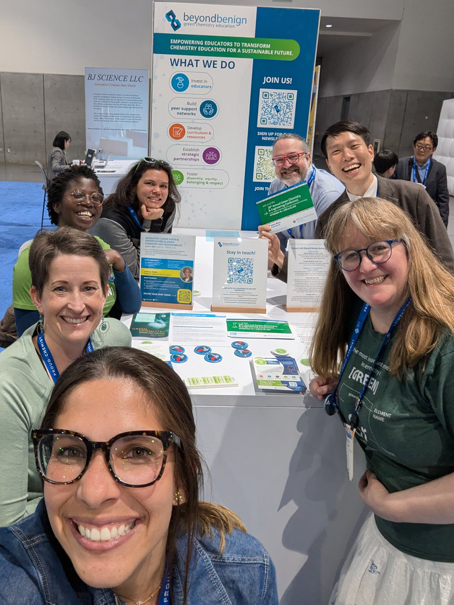 The Green Chemistry Commitment smiling to camera with some worksheets