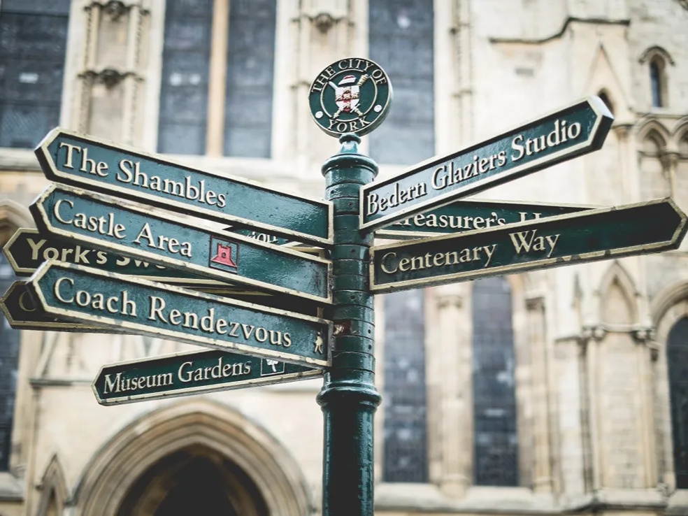 Green signpost directing to places in York