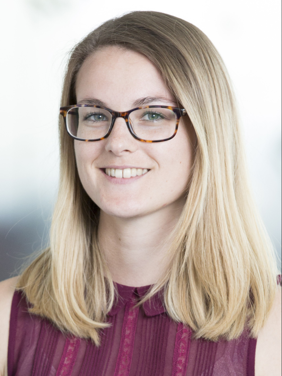 Carri Cotton smiling to camera wearing glasses, headshot