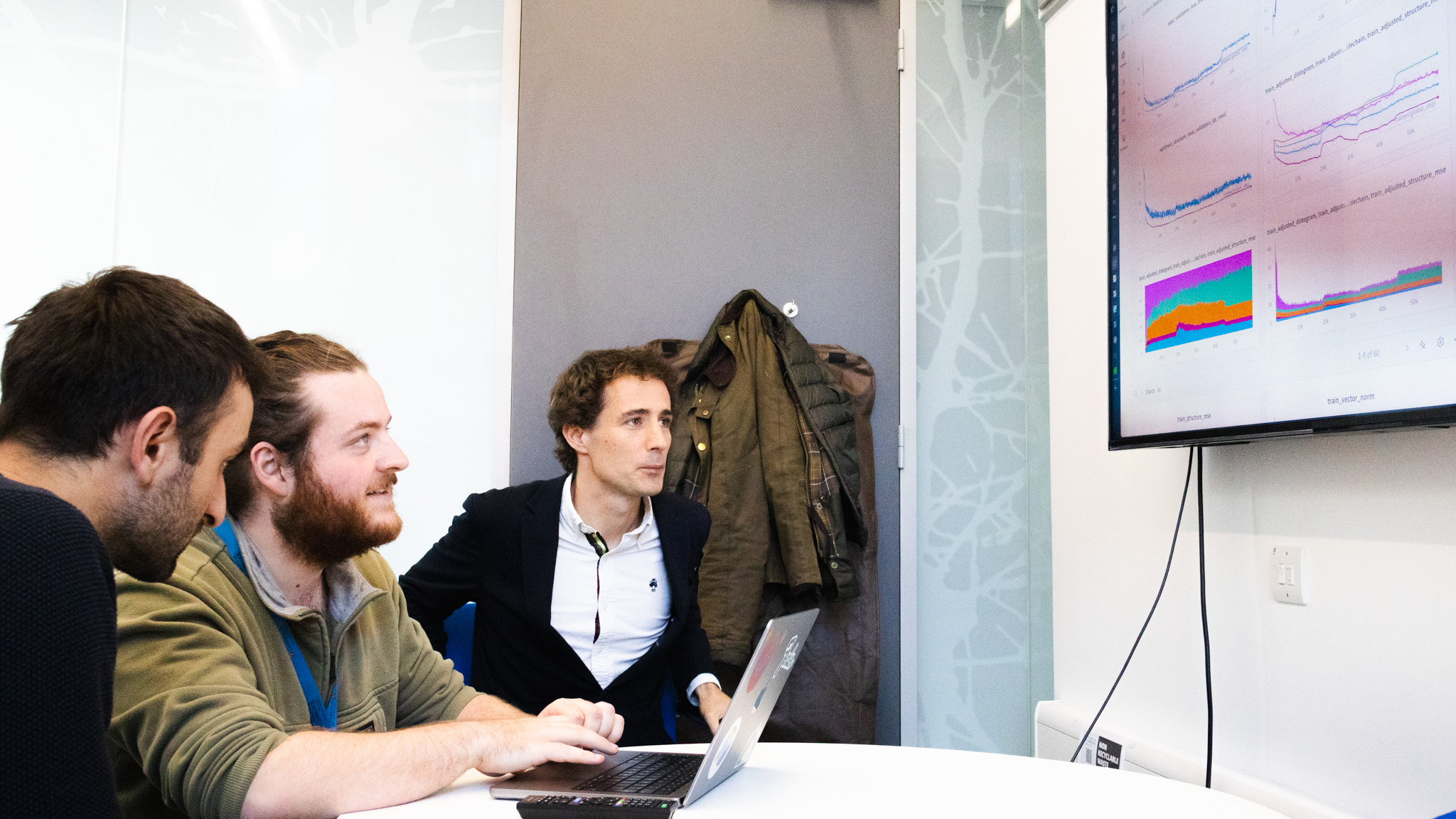 Dr Pietro Sormanni with colleagues looking at a screen of data