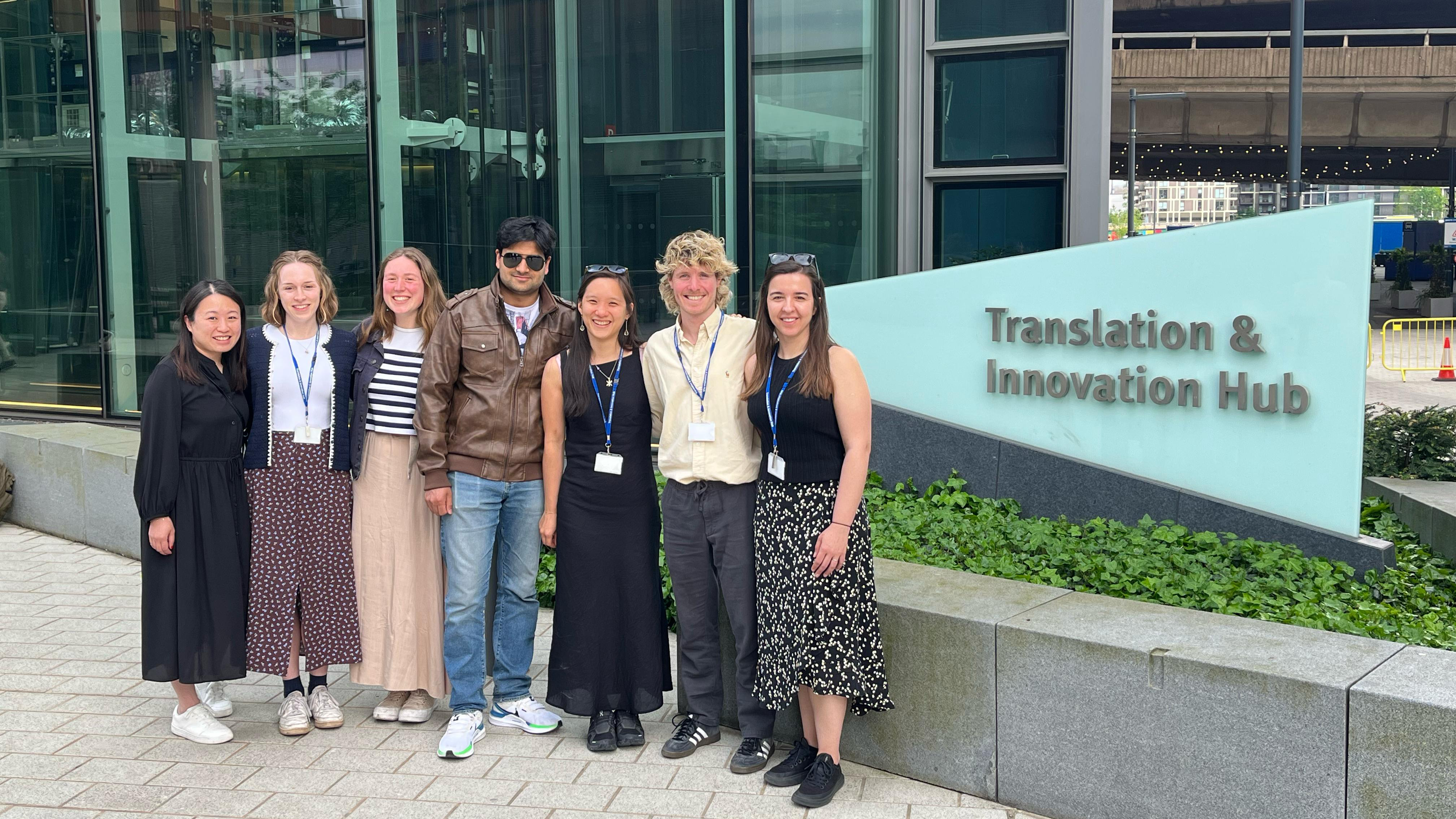 Dr Florence Huynh with a group of people posing for a photo outsisde the Translation and Innovation hub