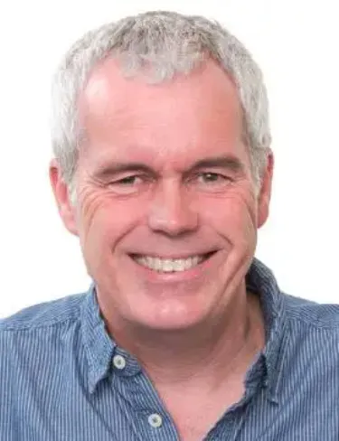 Pete Wilde Professor Pete Wilde smiling with short grey hair and a blue button-up shirt, set against a plain white background.