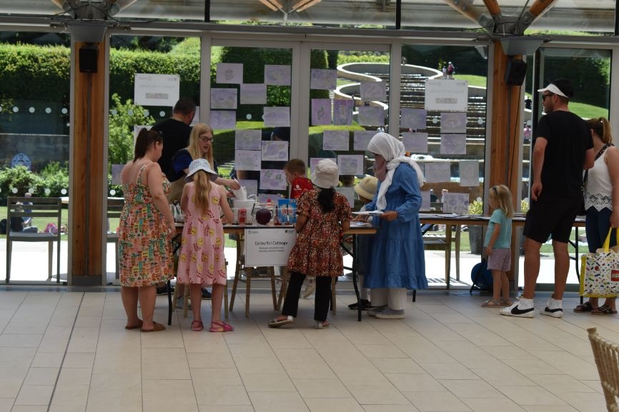 Families gather at an activity table at the Poison Garden at Alnwick Garden