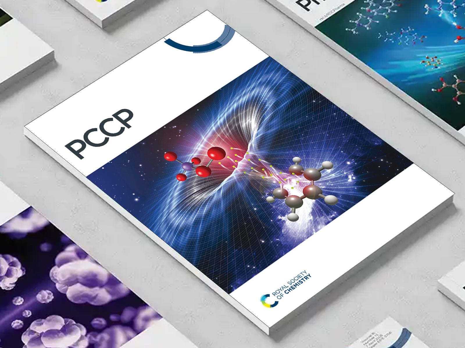 the PCCP journal among a group of other journals on a desk