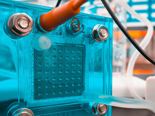 A close up photograph of a hydrogen fuel cell with wires connected