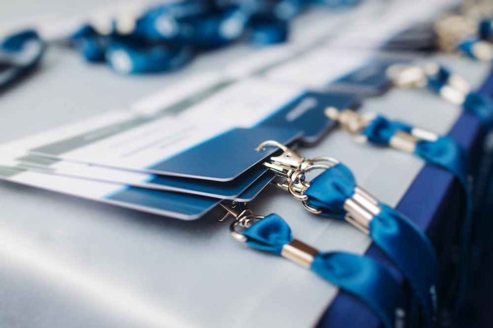 Close up photo of badges laid out at event registration