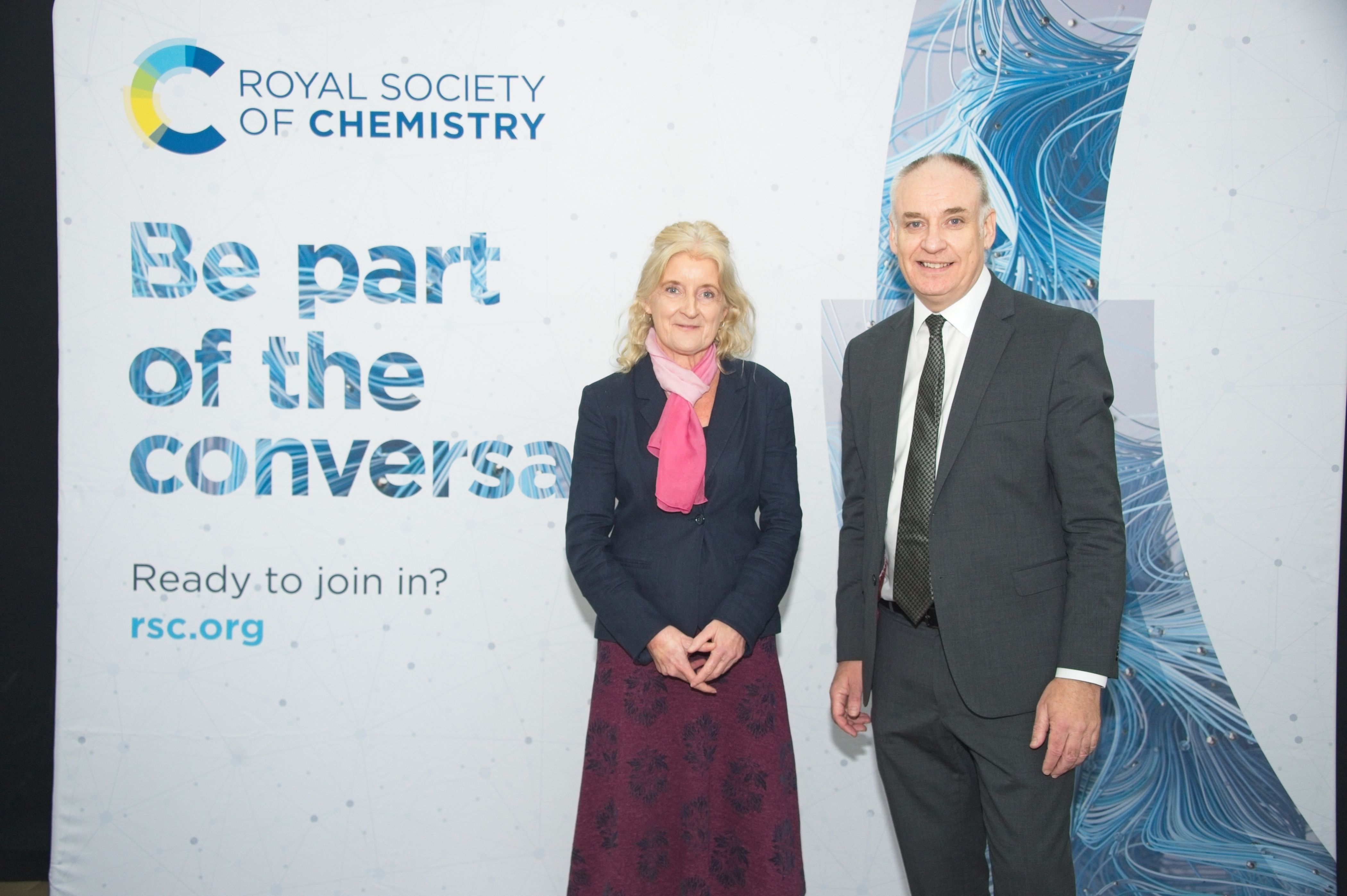 RSC President Dr Annette Doherty and Scottish Minister for Business Richard Lochhead MSP stand in front of an RSC banner at Our Dynamic Earth, Edinburgh